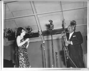 George Wein's official Newport Jazz Festival returned to the city by the sea in 1962. Carol is seen here performing on stage with jazz giant Coleman Hawkins.